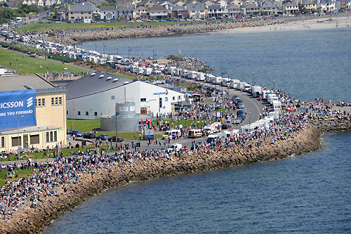 A line of camper vans parked along the shore reveal that many of the thousands of spectators gathered at Salthill to watch the In-port race in Galway Bay, had travelled from far and wide for the Volvo Ocean Race. Photo copyright Rick Tomlinson / Volvo Ocean Race.