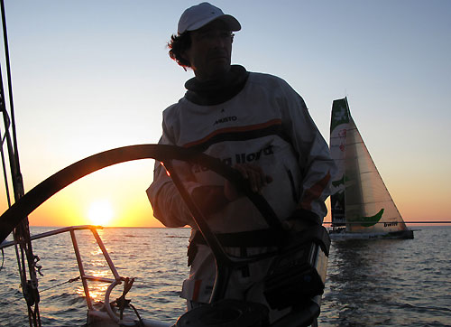 Onboard Delta Lloyd with skipper Roberto Bermudez (ESP) at the helm with Green Dragon in the background, at sunset during leg 10 from Stockholm to St Petersburg. Photo copyright Sander Pluijm / Team Delta Lloyd / Volvo Ocean Race.