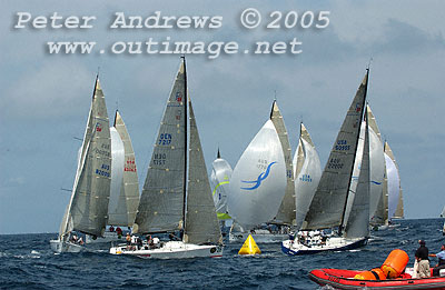 Swirling around the bottom right-hand mark are Barking Mad and Nanoq, with a mass of spinnakers ploughing down to the gate during Race 8 of the 2005 Rolex Farr 40 Worlds, offshore Sydney Australia.