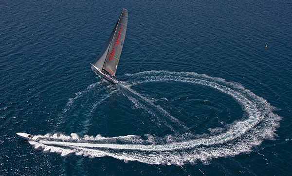 A motorboat rounding Neville Crichton's Alfa Romeo after the start of the 56th Giraglia Race off St Tropez.