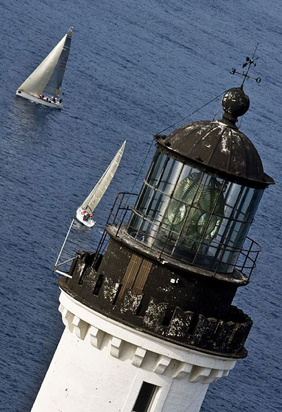 Marco Paolucci's Tartaruga sails past the Giraglia Rock Lighthouse.