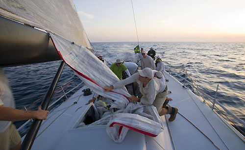 Crew stowing a spinnaker onboard Jim Swartz's STP65 Moneypenny at dusk, during the first day of the Rolex Middle Sea Race 2008. Photo copyright ROLEX and Daniel Forster.
