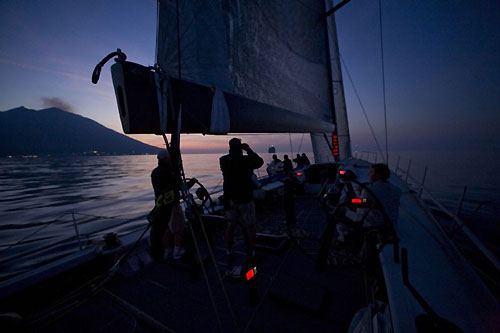 Onboard Jim Swartz's STP65 Moneypenny, making slow progress around Stromboli just before dark during the Rolex Middle Sea Race 2008. The lighthouse light on Stromboliccio ahead marks the turning point. Photo copyright ROLEX and Daniel Forster.