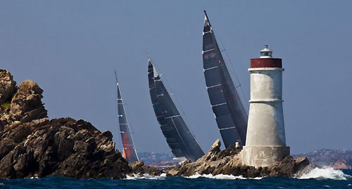 Maxi fleet passing Capo Testa Lighthouse with Luca Bassani Antivari's Wally 130 (MON); Hasso Plattner's Baltic 147 Visione (GER); and Aniene and Faruffini's Roma-Aniene (ITA), during the Maxi Yacht Rolex Cup 2009. Photo copyright Rolex - Carlo Borlenghi.
