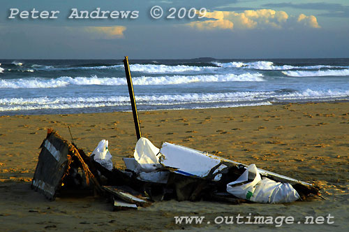 Carbon fibre and other remains from Shockwave 5, stacked by local Surf Lifesavers for collection after washing up on Corrimal Beach, NSW Australia. Photo copyright Peter Andrews.