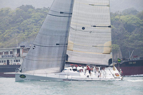 Neil Pryde's Welbourne 52 Custom HIFI passing some local shipping on Hong Knog Harbour after the start of the Rolex China Sea Race 2010. Photo copyright Daniel Forster, Rolex.