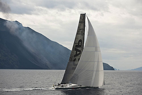 Mike Slade's ICAP Leopard passing Stromboli while in eruption, during the 31st Rolex Middle Sea Race. Photo copyright Rolex and Kurt Arrigo.