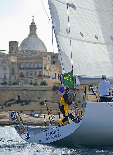 Bryon Ehrhart's TP52 Lucky arrives at the finish, during the 31st Rolex Middle Sea Race. Photo copyright Rolex and Rene Rossignaud.