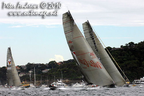 Wild Oats XI passing Investec Loyal, after the start of the Rolex Sydney Hobart 2010. Photo copyright Peter Andrews, Outimage Australia.