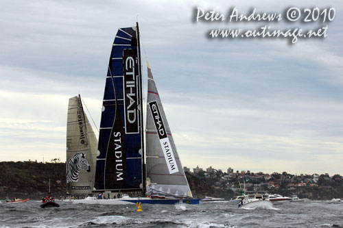 Grant Wharington's Maxi Wild Thing passing Investec Loyal, after taking the East channel out of Sydney Harbour after the start of the Rolex Sydney Hobart 2010. Photo copyright Peter Andrews, Outimage Australia.