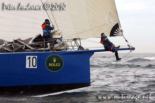 The bowman at work on Grant Wharington's Maxi Wild Thing, outside the heads after the start of the Rolex Sydney Hobart 2010. Photo copyright Peter Andrews, Outimage Australia.