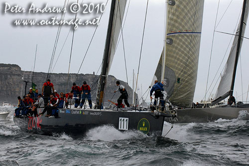 Ludde Ingvall's 90 foot maxi YuuZoo and Niklas Zennström’s Rán, outside the heads after the start of the Rolex Sydney Hobart 2010. Photo copyright Peter Andrews, Outimage Australia.