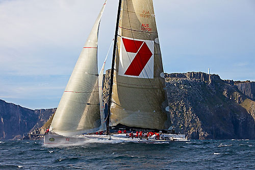 Line Honours Winner Wild Oats XI, skippered by Mark Richards, rounds Tasman Island, during the Rolex Sydney Hobart 2010. Photo copyright Rolex and Daniel Forster.