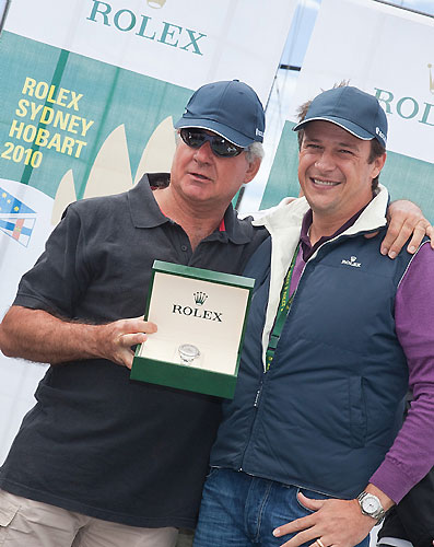 Owner skipper Geoff Boettcher of the overall handicap winner Secret Mens’ Business 3.5, at a dockside presentation in Hobart with Patrick Boutellier of Rolex Australia. Photo copyright Rolex and Daniel Forster.
