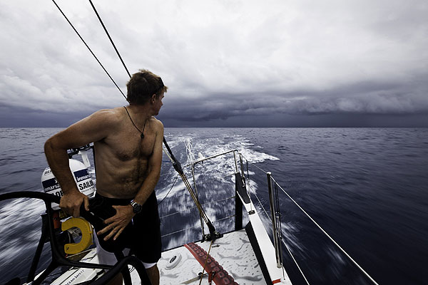 Ken Read looks back at some weather forming near the exit of the Doldrums. PUMA Ocean Racing powered by BERG during leg 1 of the Volvo Ocean Race 2011-12, from Alicante, Spain to Cape Town, South Africa. Photo Amory Ross / PUMA Ocean Racing / Volvo Ocean Race.