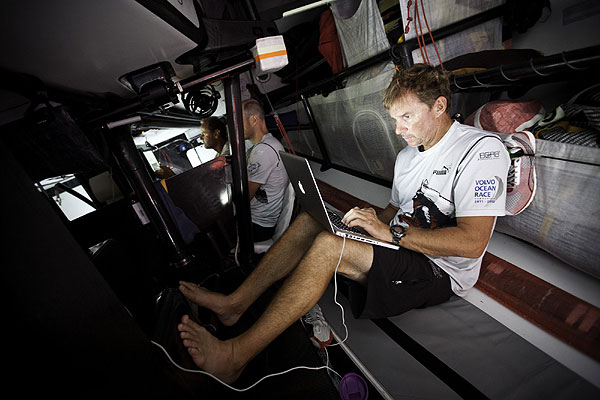 Skipper Ken Read writing emails down below. PUMA Ocean Racing powered by BERG during leg 1 of the Volvo Ocean Race 2011-12, from Alicante, Spain to Cape Town, South Africa. Photo Amory Ross / PUMA Ocean Racing / Volvo Ocean Race.