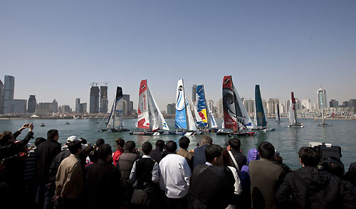 Spectators watching the racing in front of Qingdao skyline, during the Extreme Sailing Series 2011, Qingdao, China. Photo copyright Lloyd Images.