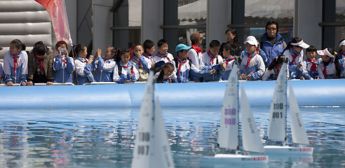 Local children race remote controlled boats in the race village, during the Extreme Sailing Series 2011, Qingdao, China. Photo copyright Lloyd Images.