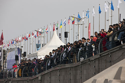 Spectators line the shoreside to watch the racing in Qingdao, during the Extreme Sailing Series 2011, Qingdao, China. Photo copyright Lloyd Images.