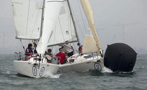 RHKYC Spring Regatta Day 2. A tight fit at the mark for the J/80s. Photo copyright Royal Hong Kong Yacht Club and Guy Nowell.