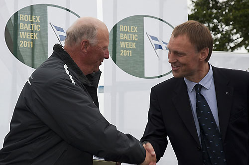 HM King Harald V of Norway receiving a silver cup for 2nd place in the Sira class by FSC chairman Jochen Frank, during the 2011 Rolex Baltic Week. Photo copyright Rolex and Daniel Forster.