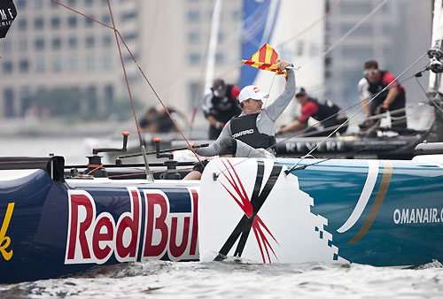 Roman Hagara skipper of Red Bull Extreme Sailing holding up a protest flag while controlling the tiller, during day 4 of the Extreme Sailing Series 2011, Boston, USA. Photo Copyright Lloyd Images.