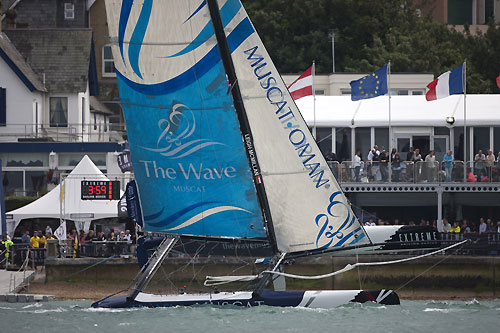 The Wave-Muscat flying in front of the Race Village back on Day 1 of the Extreme Sailing Series 2011, Cowes, United Kingdom. Photo copyright Lloyd Images.