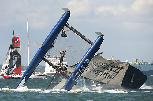 A dramatic capsize for Aberdeen Asset Management in Race 6 of Day 3 of the Extreme Sailing Series 2011, Cowes, United Kingdom. Photo copyright Lloyd Images.
