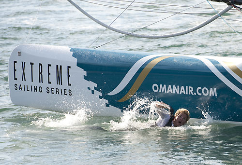 David 'Freddie' Carr leaps in to the water to manhandle Oman Air Extreme 40 off the beach at the Extreme Sailing Series 2011, Cowes, United Kingdom. Photo copyright Lloyd Images.
