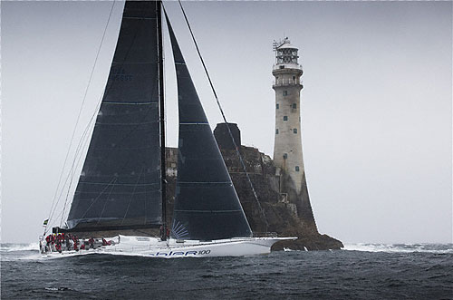 George David's Rambler 100 rounding the Fastnet Rock, during the Rolex Fastnet Race 2011. Photo copyright Rolex and Daniel Forster.