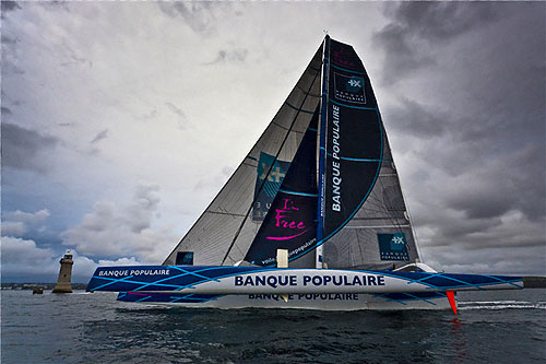 Loick Peyron's Maxi Banque Populaire crossing the finish line off Plymouth, during the Rolex Fastnet Race 2011. Photo copyright Rolex and Carlo Borlenghi.