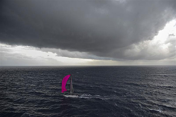 The pink spinnaker of Grard Logel's Arobas (FRA) is contrasted by dark skies as she approaches the Aeolian Islands, during leg two of the Rolex Volcano Race 2012. Photo copyright Kurt Arrigo for Rolex.