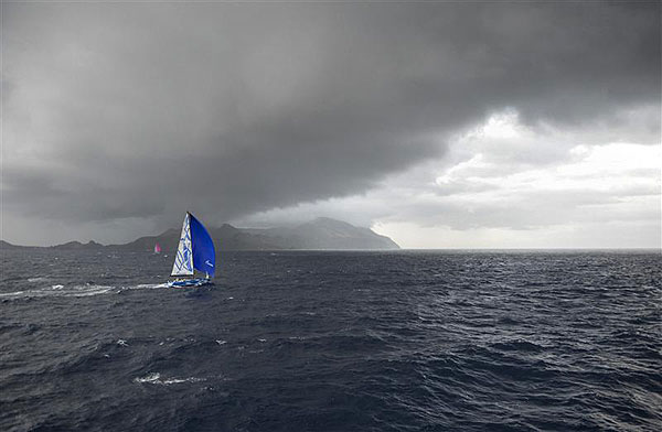 Vladimir Liubonirov's Bronenosec (RUS) sails towards the storm, with Grard Logel's Arobas (FRA) in the distant background, during leg two of the Rolex Volcano Race 2012. Photo copyright Kurt Arrigo for Rolex.