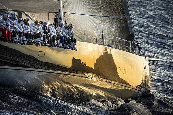 Filip Balcaen's 112-ft Supermaxi Nilaya (BEL), sails towards her leg two line honours win with Capri reflected on her bow, during the Rolex Volcano Race 2012. Photo copyright Kurt Arrigo for Rolex.