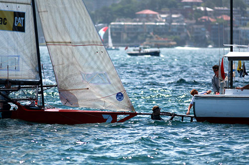 Defending champion and pre race favourite, Seve Jarvin's Gotta Love It 7, collided with the stern of the starter boat and was an immediate retiree, during Race 1 of the Australian 18 foot Skiff Championship on Sydney Harbour. Photo copyright The Australian 18 Footers League.
