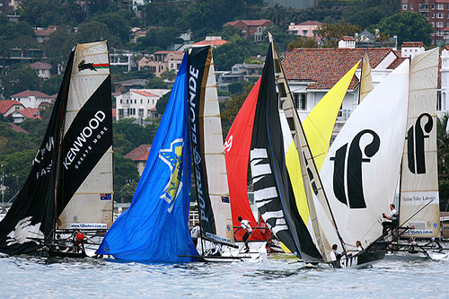 The fleet bunched up and looking for breeze, during Race 13 of the Club Championship Race. Photo copyright Australian 18 Footers League.