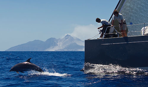 Antigua 21-02-2010. DSK Pioneer Investments sailing with dolphins off Montserrat's active volcano, the day before the start of the RORC Caribbean 600. Photo copyright Carlo Borlenghi.