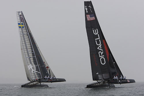 James Spithill's ORACLE Racing and Terry Hutchinson's Artemis Racing on a foggy Day 1 of the America's Cup World Series, Cascais, Portugal, August 6-14, 2011. Photo copyright Morris Adant.