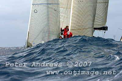 The three crew in the centre of the photo are standing on the bow of Rob Hanna's Shogun hidden by a wave with Ian Paterson's Rush providing a backdrop.