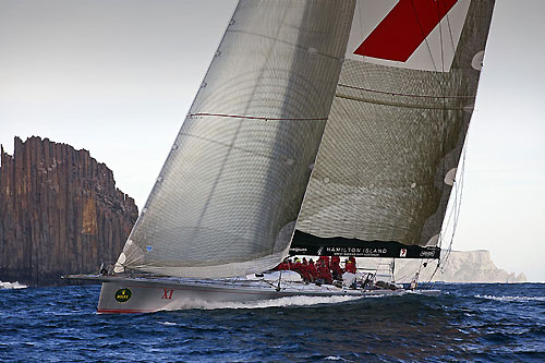 Line Honours Winner Wild Oats XI at the Organ Pipes, off Cape Raoul with Tasman Island in the background, during the Rolex Sydney Hobart Yacht Race 2010. Photo copyright Rolex and Daniel Forster.