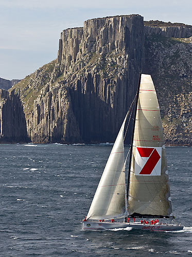 Wild Oats XI skippered by Mark Richards, rounds Tasman Island, during the Rolex Sydney Hobart 2010. Photo copyright Rolex and Carlo Borlenghi.
