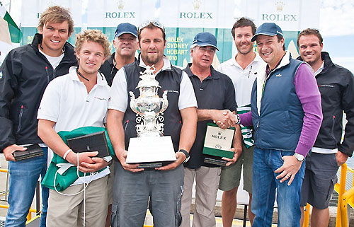 The crew of Secret Mens’ Business 3.5, overall handicap winners, at a dockside presentation in Hobart for division winners. Seen here with Patrick Boutellier of Rolex Australia and the Tattersalls Cup. Photo copyright Rolex and Daniel Forster.